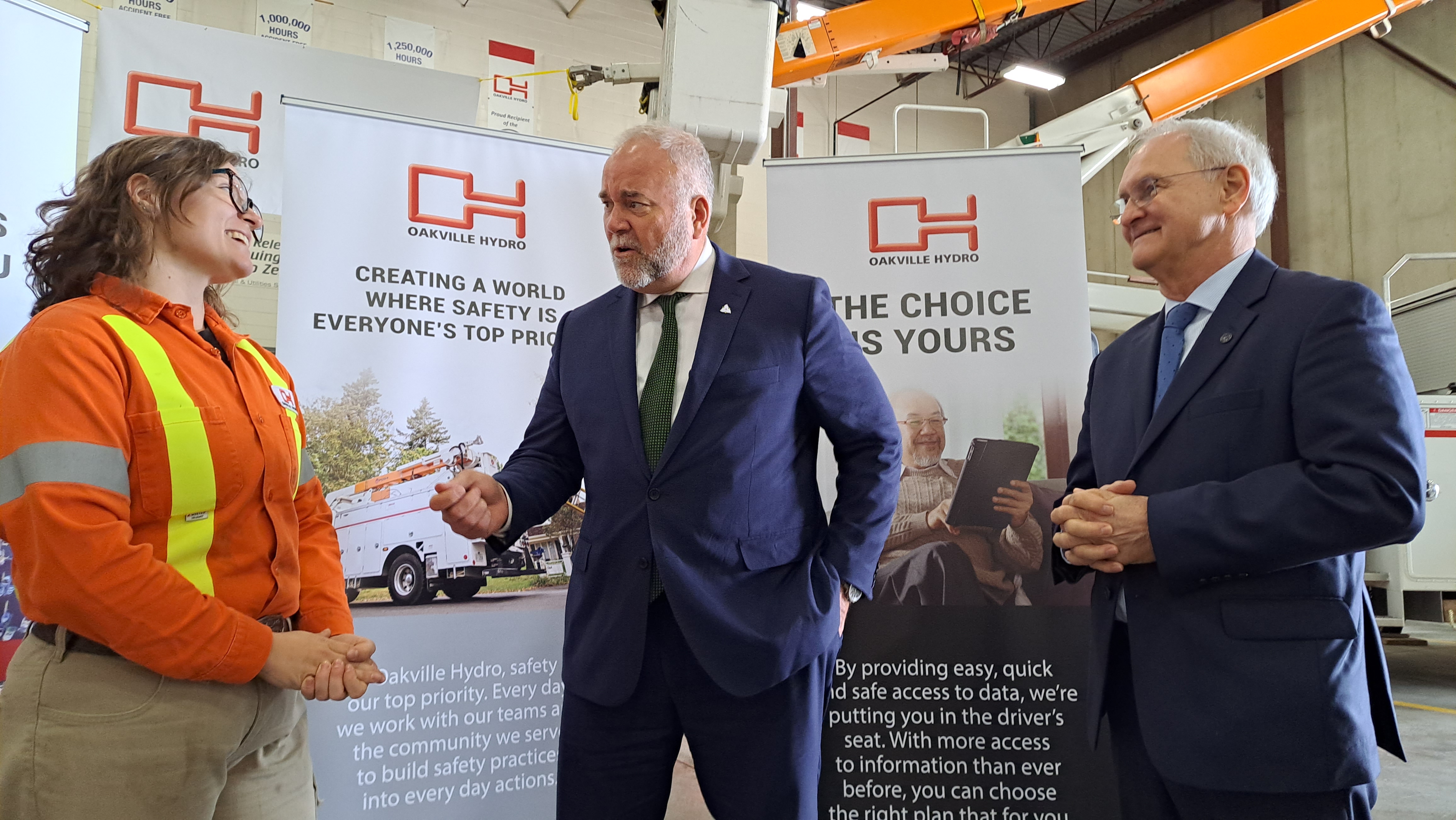 Oakville Hydro employee speaking with Minister Smith and Oakville Hydro President and CEO Rob Lister at the Green Button launch | Oakville Hydro